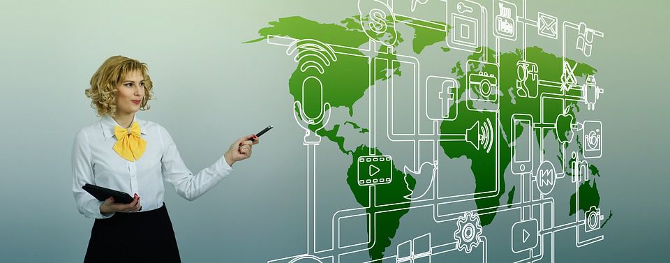Young woman pointing to a intertwined network of marketing elements coming together ove the map of the world.
