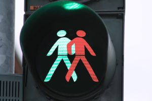 Traffic light with both green and red pedestrians.