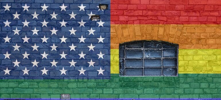 Wall painted in rainbow colours, with the american flag stars in the corner.