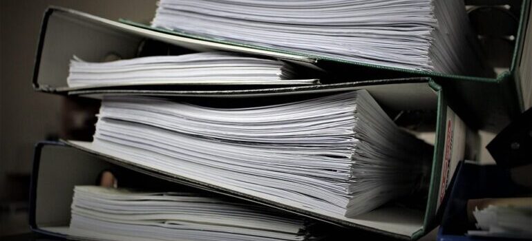 Business paperwork and files on a pile.
