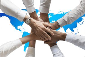 All hands put together ove the map of the world.