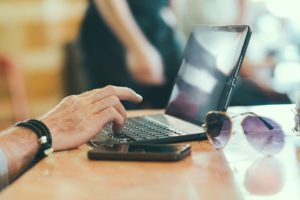 Person on a laptop, preparing to streamline their business with software.