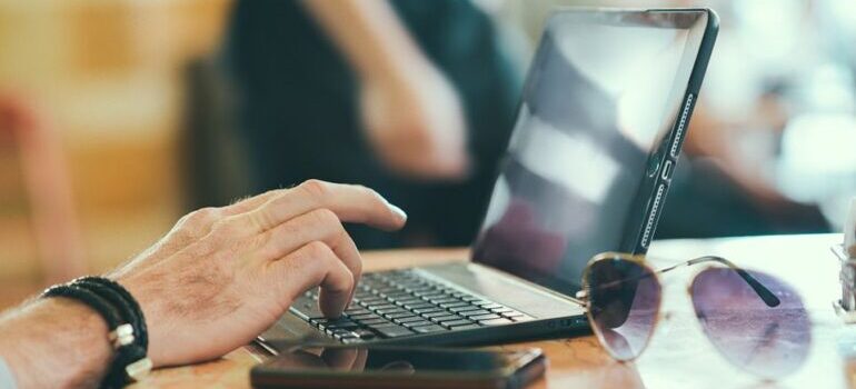 Person on a laptop, preparing to streamline their business with software.