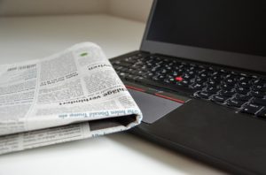 Newspaper on a laptop.