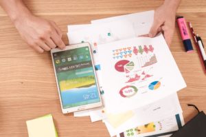 Mobile device with stats and development plans on a table.