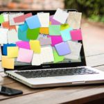 Countless sticky notes on a laptop screen.