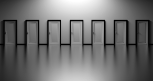 Multiple white doors that are seemingly the same.