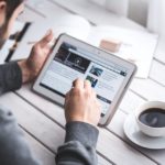 Man listing through blog while having his morning coffee.