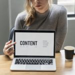 Woman pointing on Content page on laptop