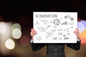 Businesswoman holding an Innovation schematic.