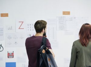 People looking at plans and ideas on whiteboard.