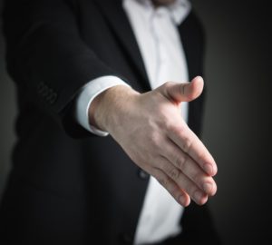 Businessman with his hand out.
