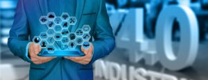 Businessman holding an iPad with industry icons.