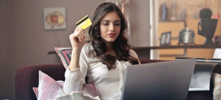 Woman with credit card and laptop