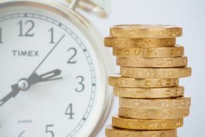 a clock and a pile of coins