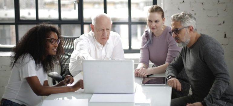 Team of people looking at laptop