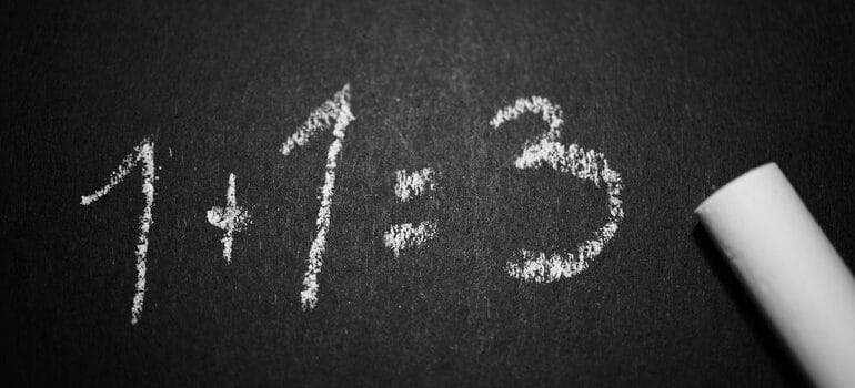 1+1=3 written in chalk.