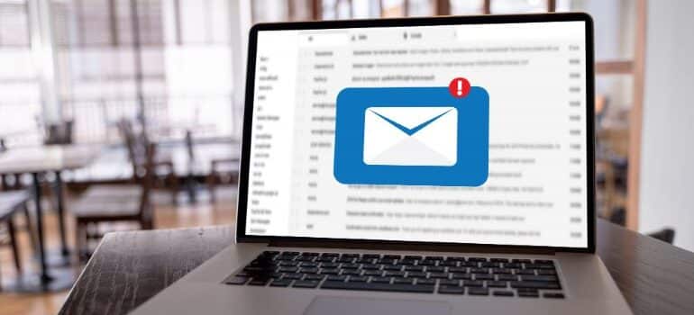 Email icon with inbox background on laptop screen.