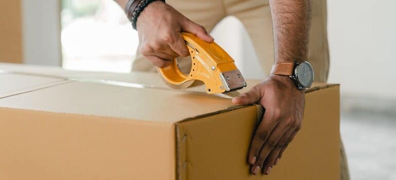 Person packing a box.