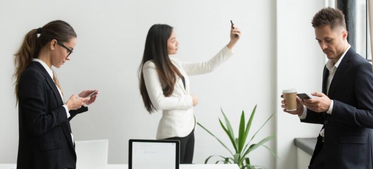 People at work looking at their phones.