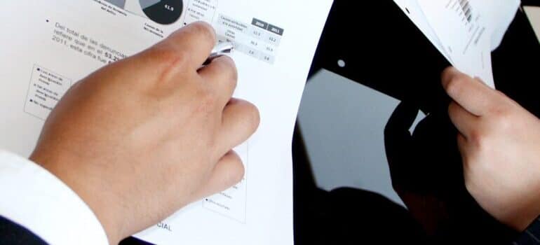 two business people holding papers