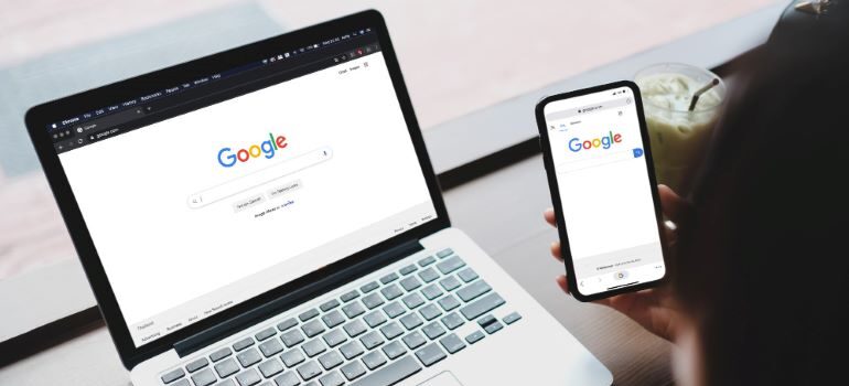 Google search page on laptop and mobile phone.