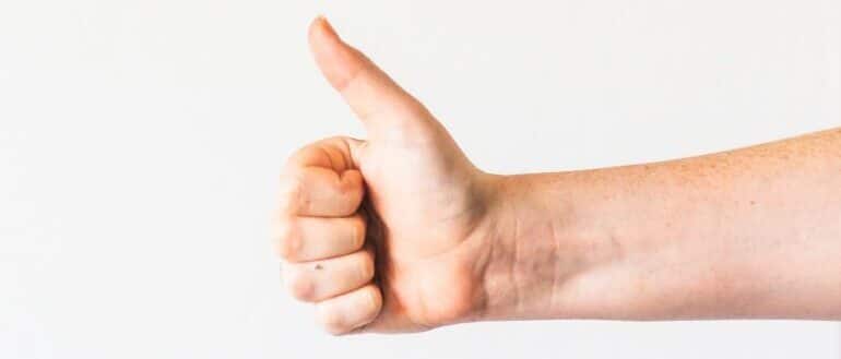 A person holding his thumb up.