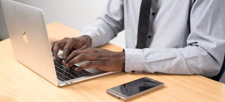 A customer service representative live chatting with a customer on a laptop.