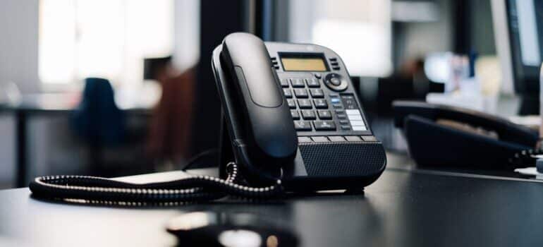 A black phone on a table.