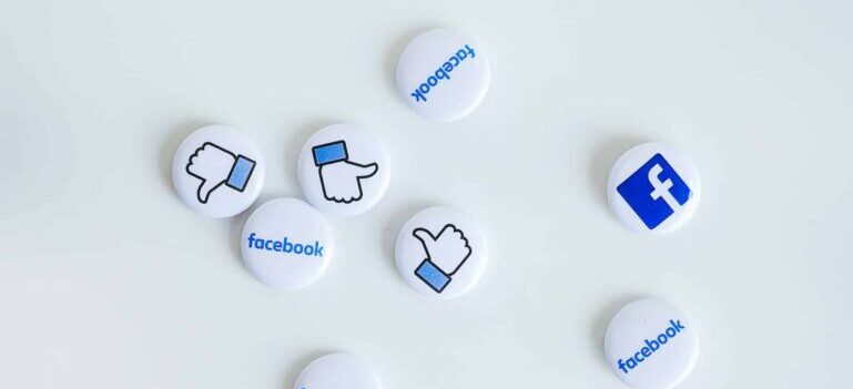 Badges bearing Facebook logos.