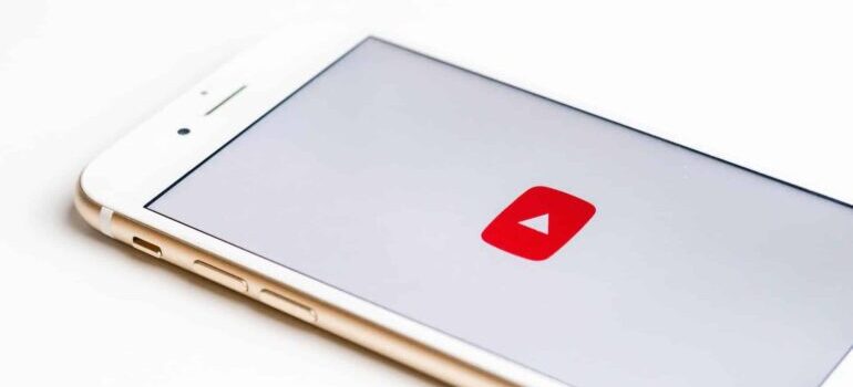 A phone with the YouTube icon displayed.