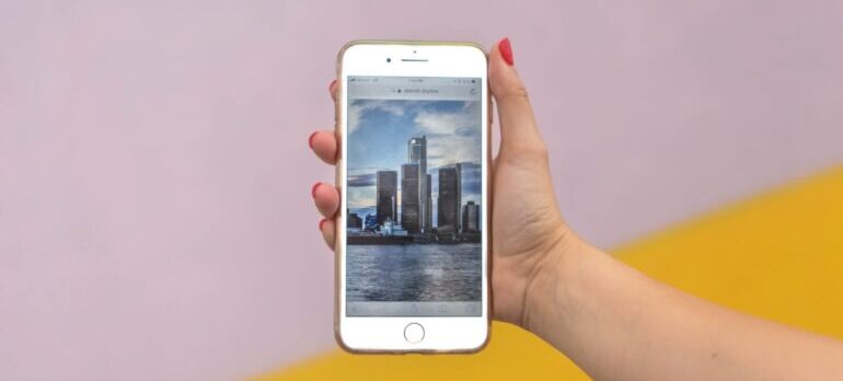 A person holding a phone with an image on it.
