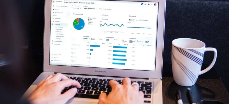A person using their laptop to look up metrics.