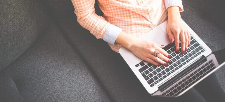 A woman creating a blog post for a moving company following off-season marketing strategy for movers