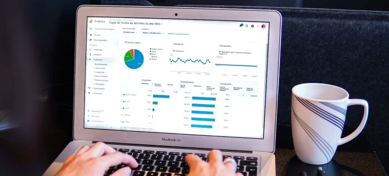A person using Google Analytics, one of the free SEO for startups tools.