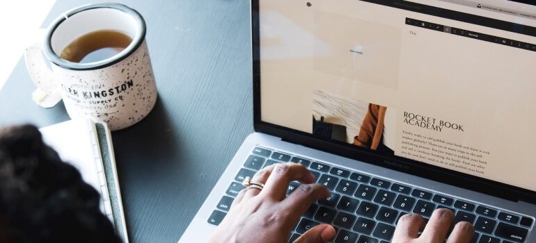 A person writing a blog post on a laptop
