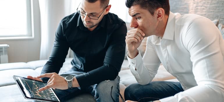 Two co-workers considering local-based ads