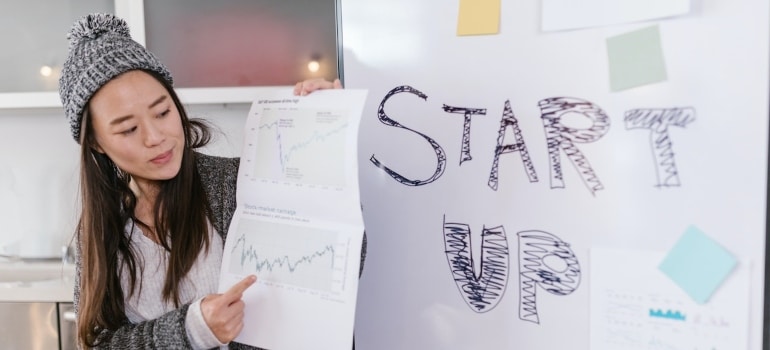 Person holding a paper with Start Up written on it