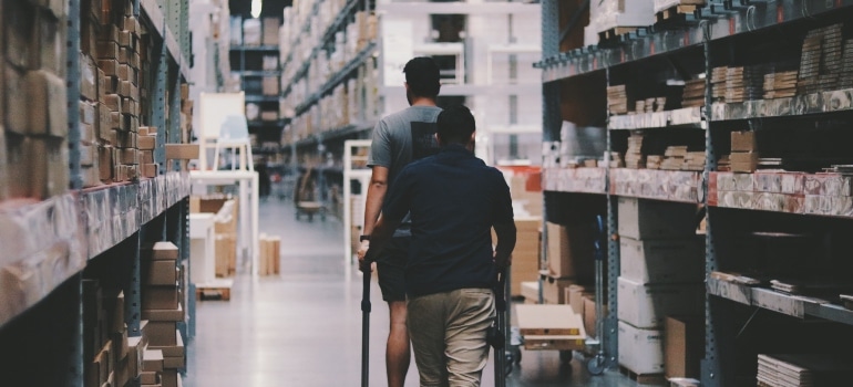 people walking through a storage facility