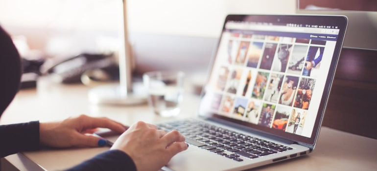 a person looking for something on a laptop