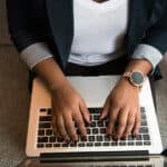A person typing on a laptop.