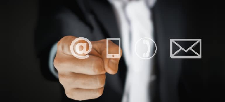 Person pointing at email icons, highlighting how to personalize emails to meet the specific needs of different client segments for better engagement.