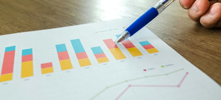 hand pointing at a graph understanding why sending regular newsletters is effective