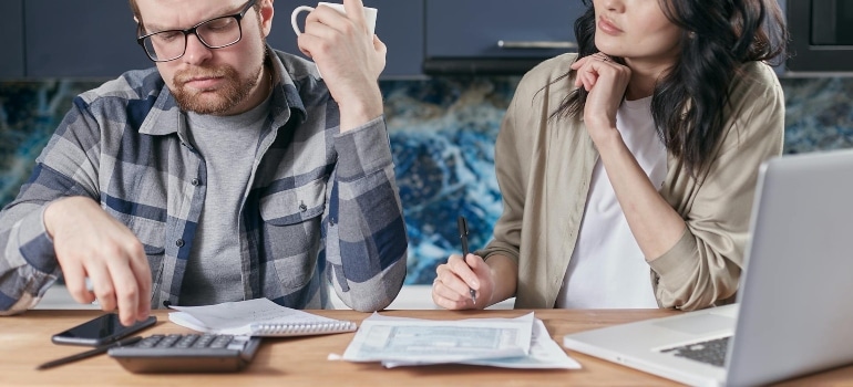 a couple doing some calculations 