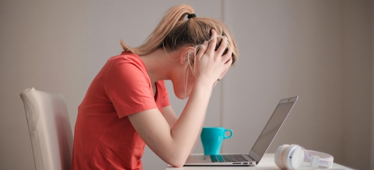 a woman looking at her laptop 