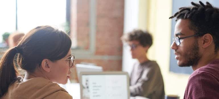 A digital marketing team discussing strategies for juggling moving operations and social media