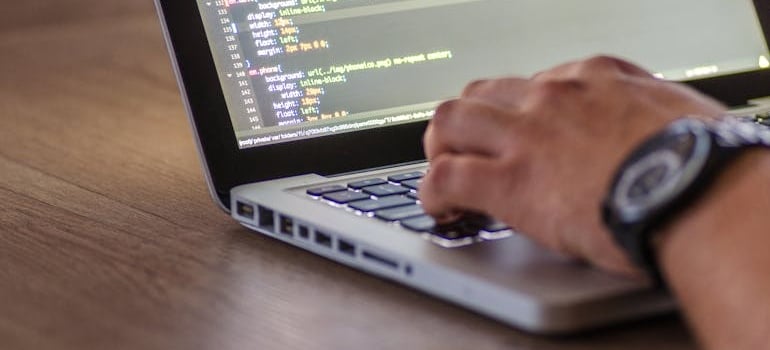 A person using a laptop to write codes