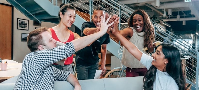 A marketing team celebrating the success of their brand development strategy for movers