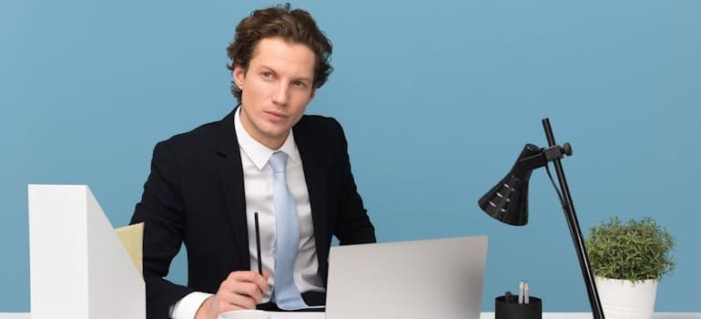 A business person thinking about the future of their company, which is an important brand development strategy for movers