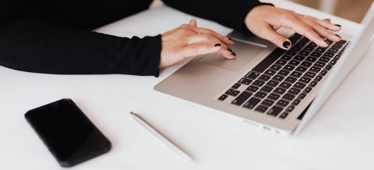 A person typing on a laptop